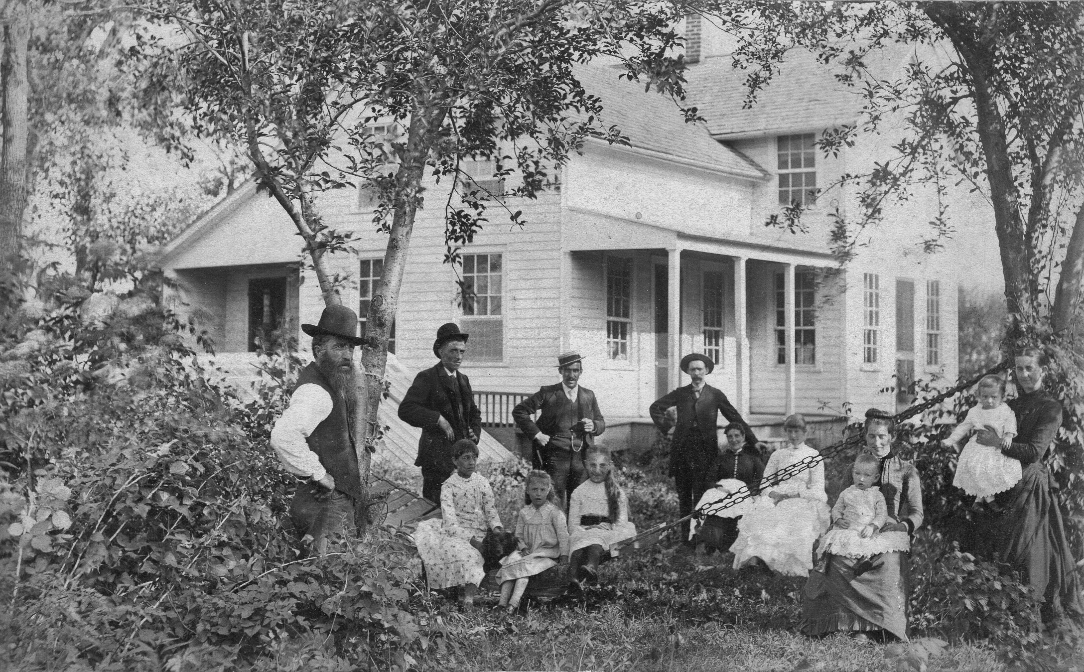 Large family in front of their Upright Wing Farmhouse ca. 1880